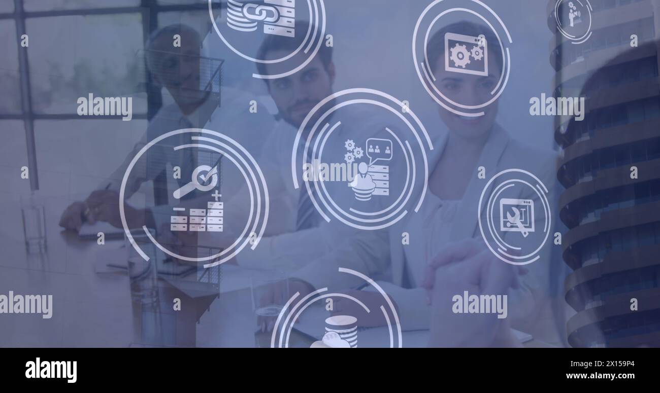 Image of technology icons over caucasian businesspeople in office. business, network, connections and technology concept digitally generated image. Stock Photo