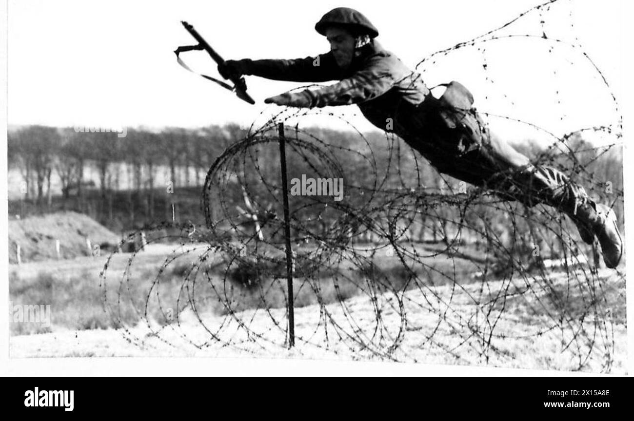 COMMANDOS IN TRAINING Demonstrating a quick way of crossing barbed