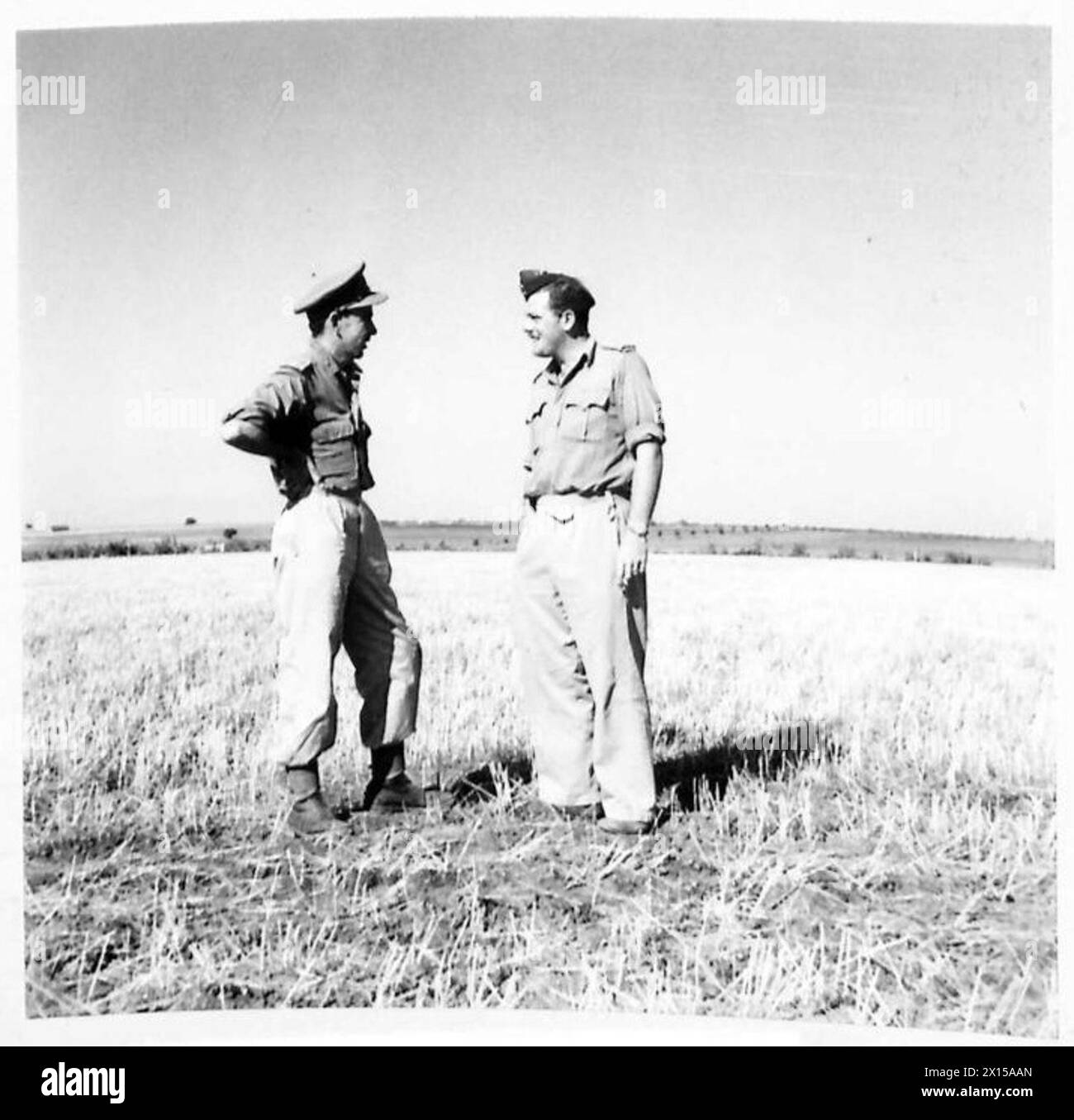 Lieutenant Lavender and Captain Preston discuss the construction of a landing ground in Italy following an air survey during British Army operations. Stock Photo