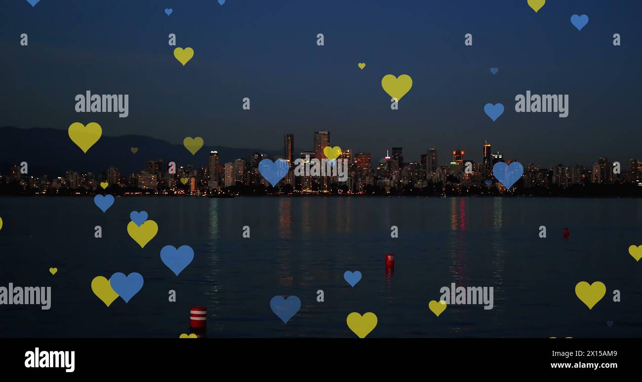 Image of yellow and blue hearts floating over night cityscape Stock ...