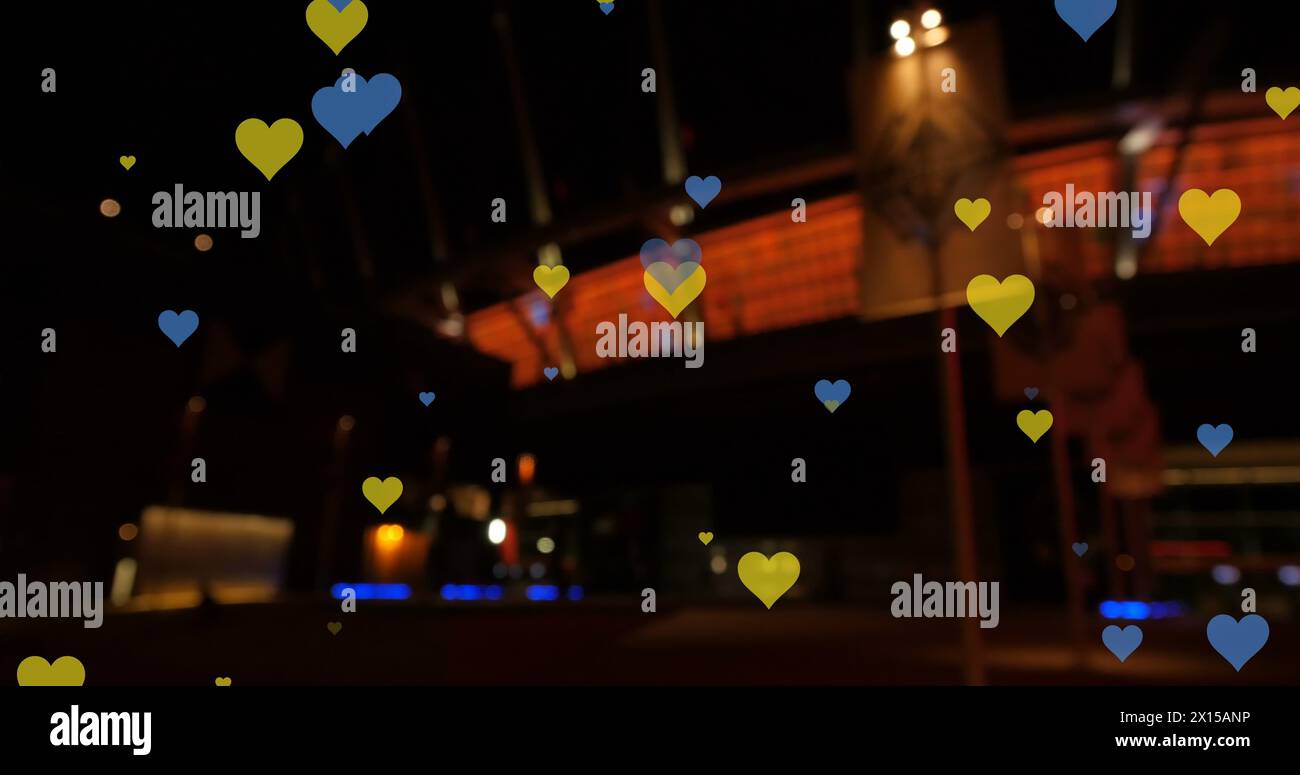 Image of yellow and blue hearts floating over night cityscape Stock ...
