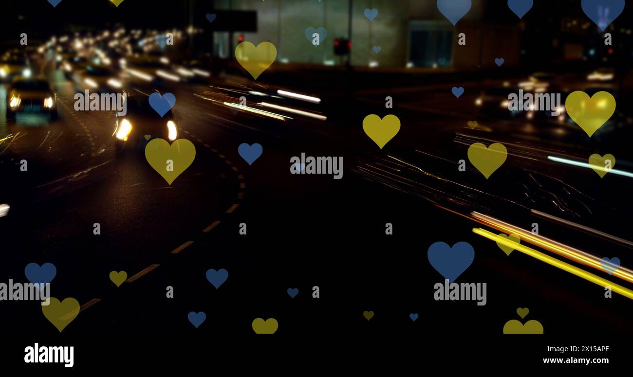 Image of yellow and blue hearts floating over night cityscape Stock ...
