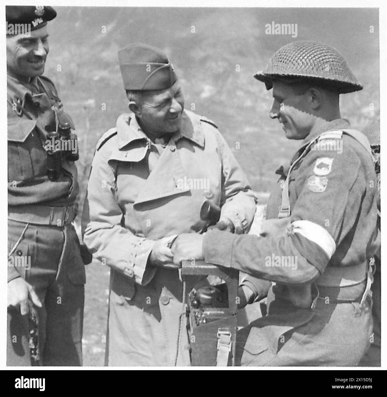 ALLIED ARMIES IN THE ITALIAN CAMPAIGN, 1943-1945 - Signalman of the 6th 'Lwów' Infantry Brigade (5th Kresowa Division, 2nd Polish Corps) explaining to General Jacob Devers, the Deputy Supreme Allied Commander of the Mediterranean Theatre, details of his telephone equipment. Smiling General Władysław Anders, the CO of the Corps, is listening to the conversation.Photograph taken during one of General Devers' frequent visit to various units of the Allied Forces British Army, American Army, Polish Army, Polish Armed Forces in the West, Polish Corps, II, Polish Armed Forces in the West, 2nd Corps, Stock Photo