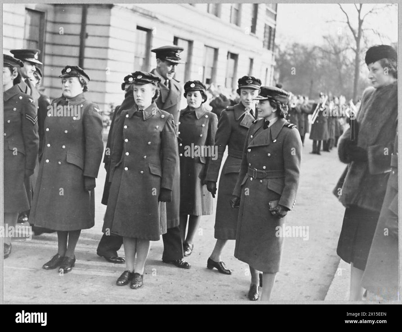 DUCHESS OF GLOUCESTER AT AIR CREW RECEPTION CENTRE - 11980 Picture (issued 1944) shows - The Duchess of Gloucester inspecting W.A.A.F. at the Depot. Air Vice marshal G.R.M. Reid [extreme left]. Group Captain A.H.H. Gilligan [Commanding Officer] and Section Officer C. Thorn accompanied her Royal Air Force Stock Photo
