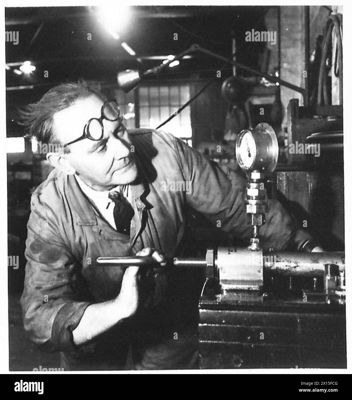 'OLD TIMERS' WORK IN REME WORKSHOPS - Mr. F.E. Wright who returned from retirement three years ago is a chargehand in the general fitters shop. He comes from Porchester, Portsmouth. For twenty-six years he served in the Royal Navy. He is 64 years of age British Army Stock Photo