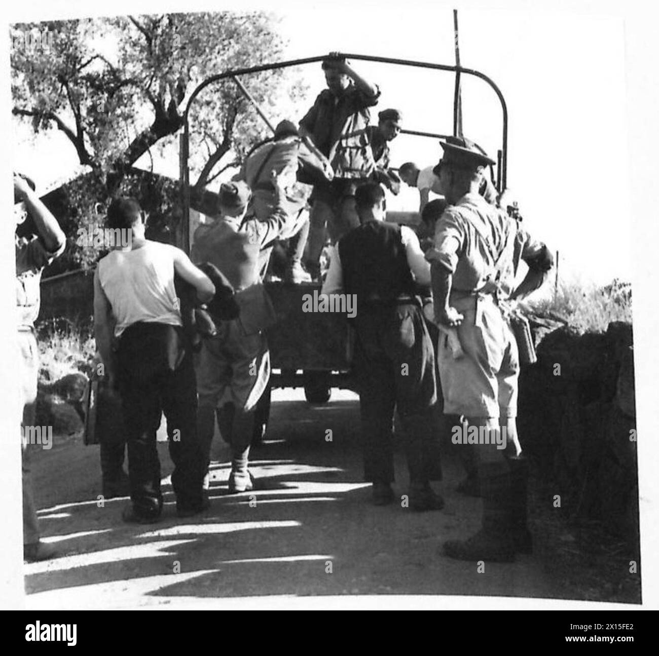 Italian prisoners are escorted to a prisoner of war camp in Sicily by ...