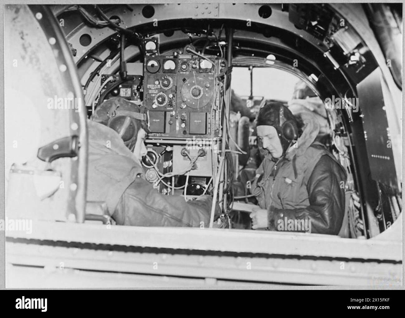 The image features a wireless operator and another crew member aboard ...