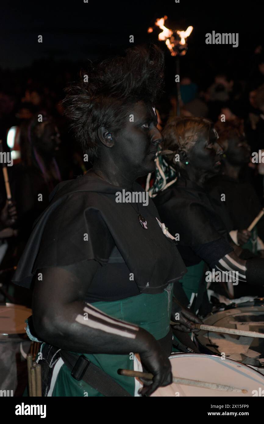 Drummers dressed in black and green and body painted in black Stock Photo