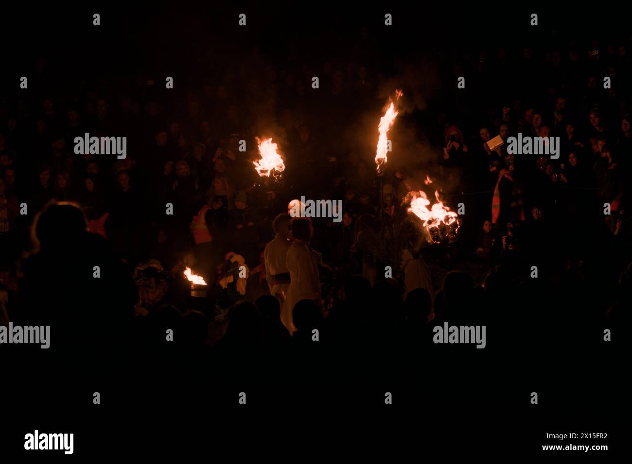 Beltane Fire Festival performers with torches at night Stock Photo