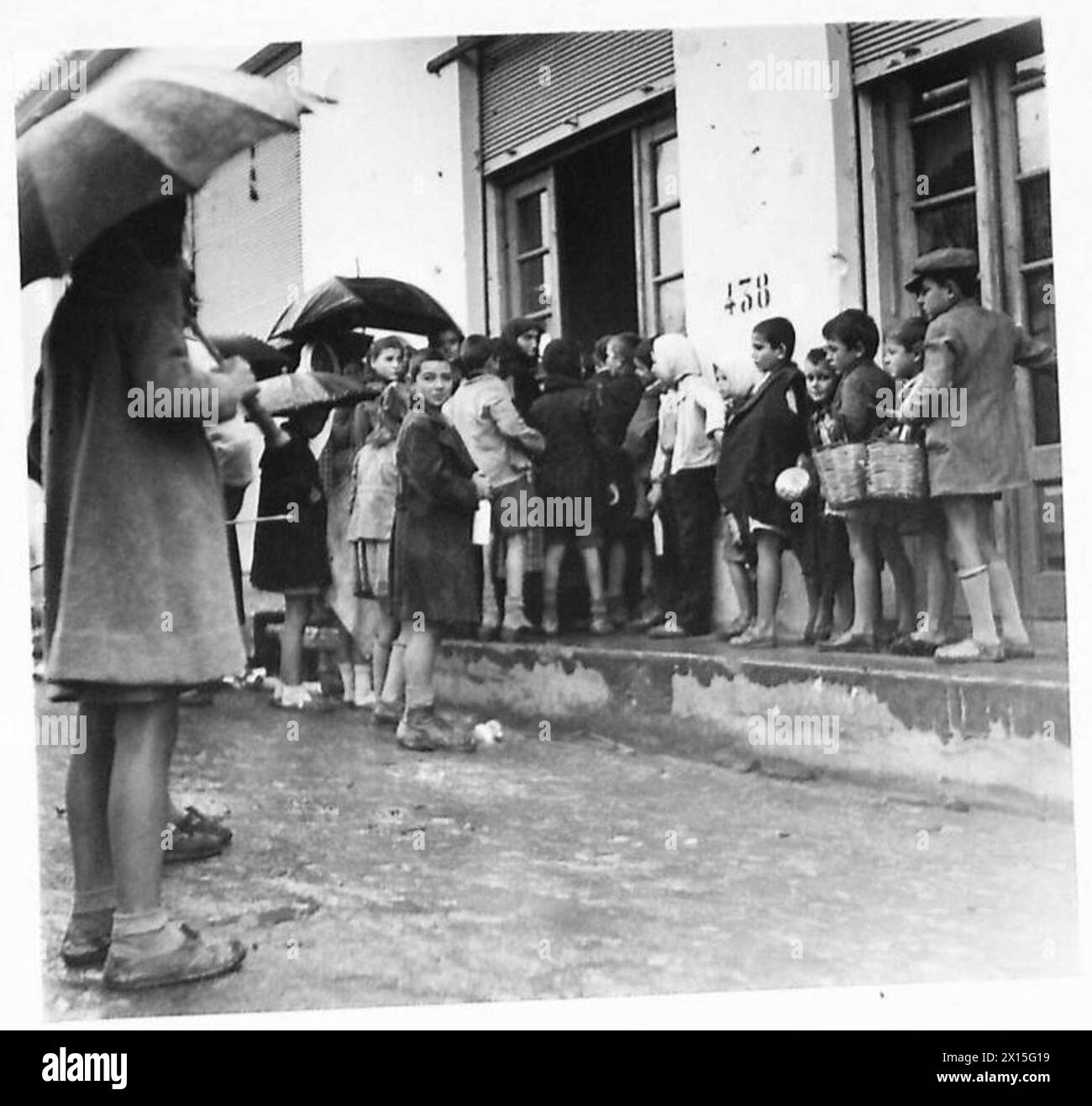 Children food distribution queue Black and White Stock Photos & Images ...