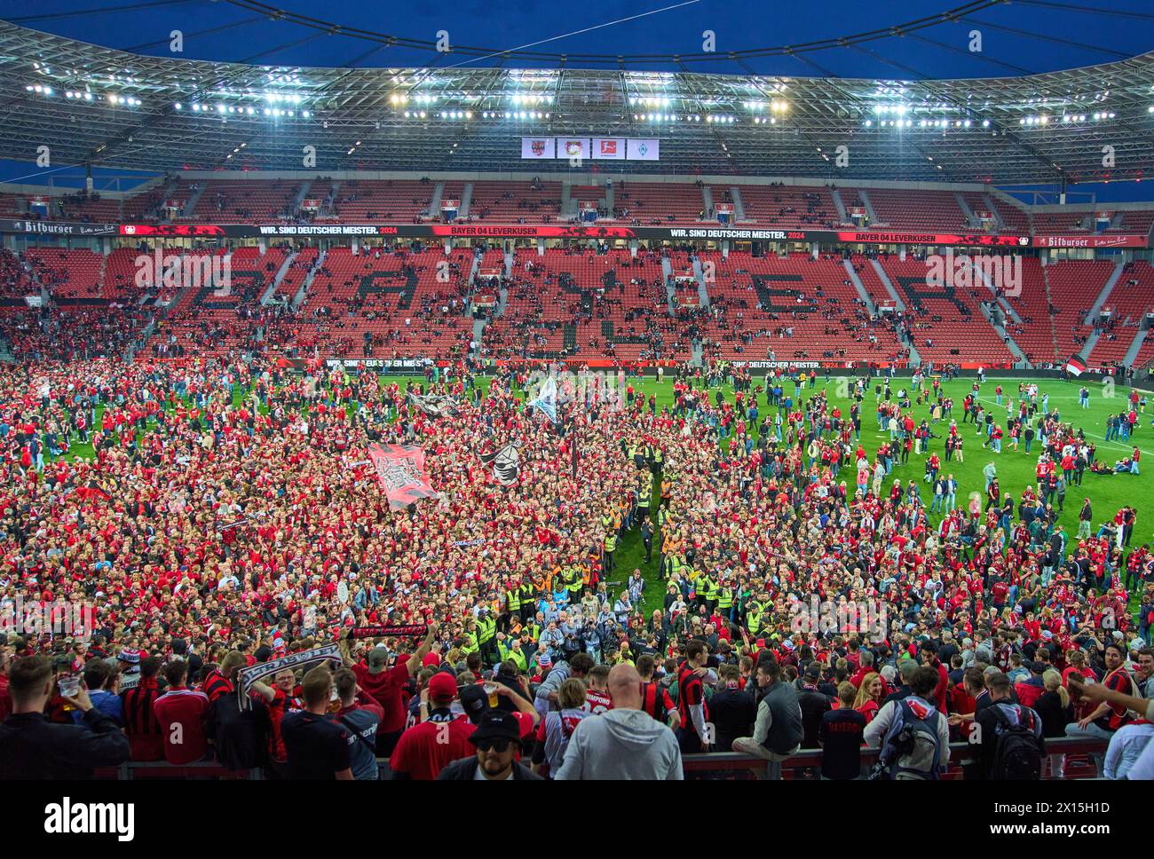 Fans enter the pitch and watch Xabi Alonso, Trainer, headcoach teammanager Leverkusen at the press conference after the match BAYER 04 LEVERKUSEN - SV WERDER BREMEN 5-0   on April 14, 2024 in Leverkusen, Germany. Season 2023/2024, 1.Bundesliga,, matchday 29, 29.Spieltag Photographer: ddp images / star-images    - DFL REGULATIONS PROHIBIT ANY USE OF PHOTOGRAPHS as IMAGE SEQUENCES and/or QUASI-VIDEO - Stock Photo