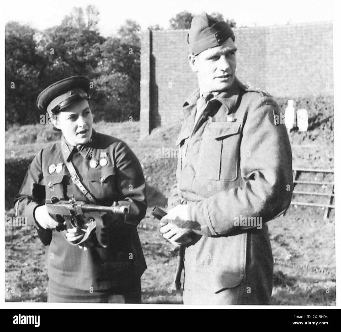 VISIT OF RUSSIAN DELEGATES TO CANTERBURY AND DOVER AREA - Lt. Lyudmila Pavlichenko fires a few rounds with a Tommy guns British Army Stock Photo