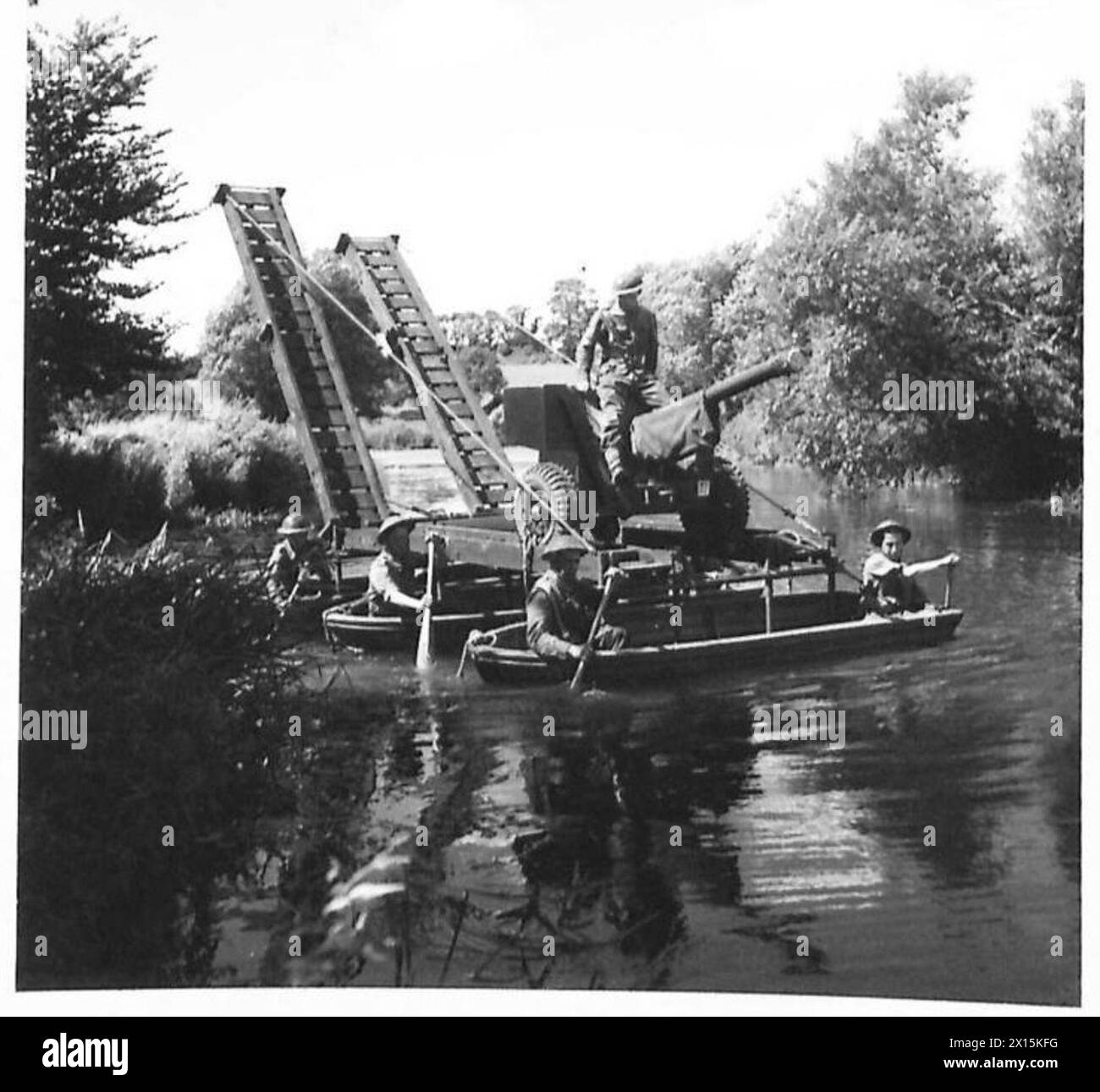 A 6-pounder gun is transported across a river on a raft during British ...