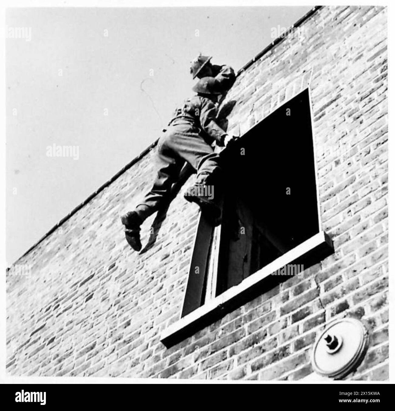 A selected trainee climbs from a window onto a roof during a toughening ...
