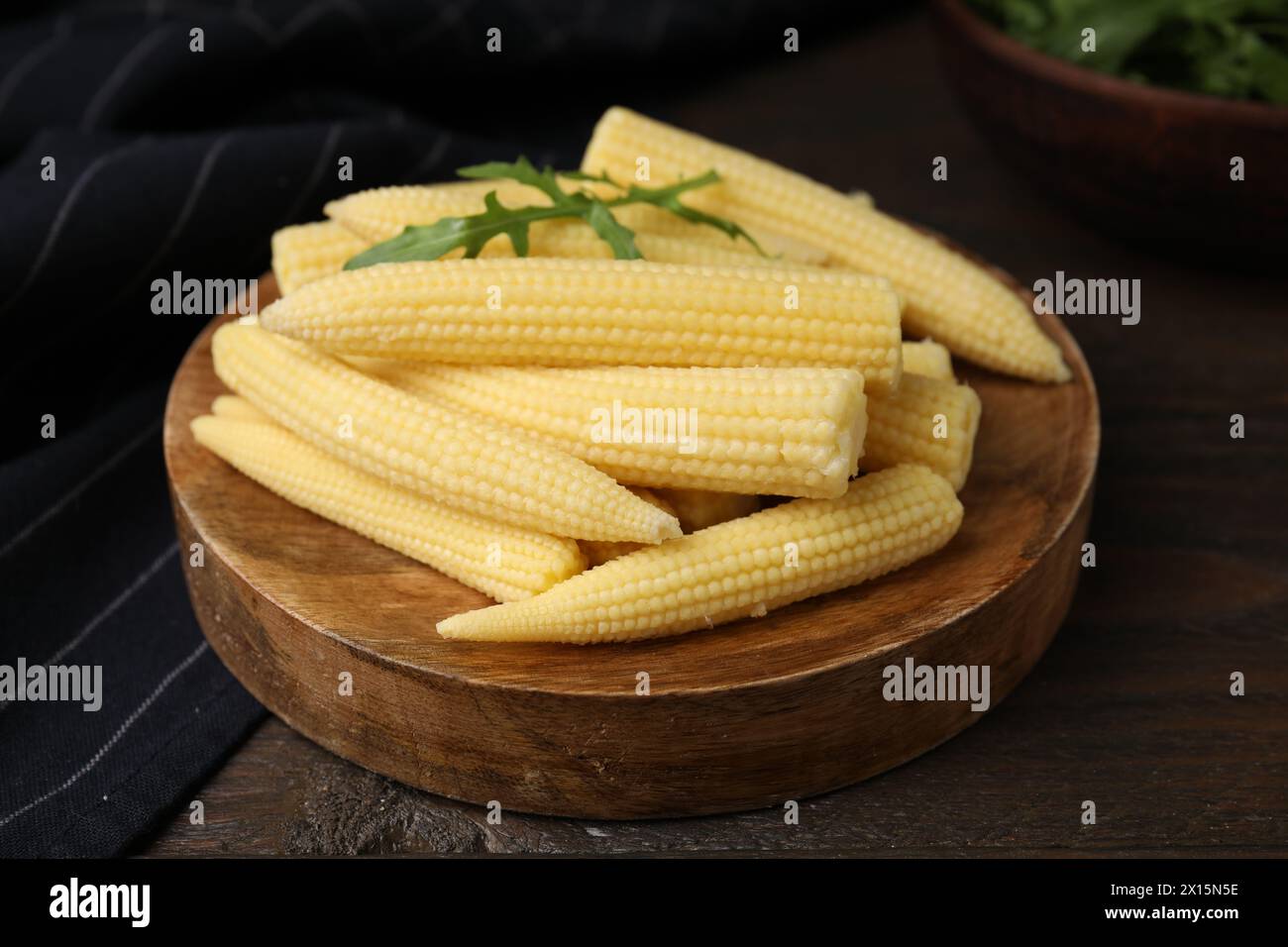 Tasty fresh yellow baby corns on wooden table Stock Photo
