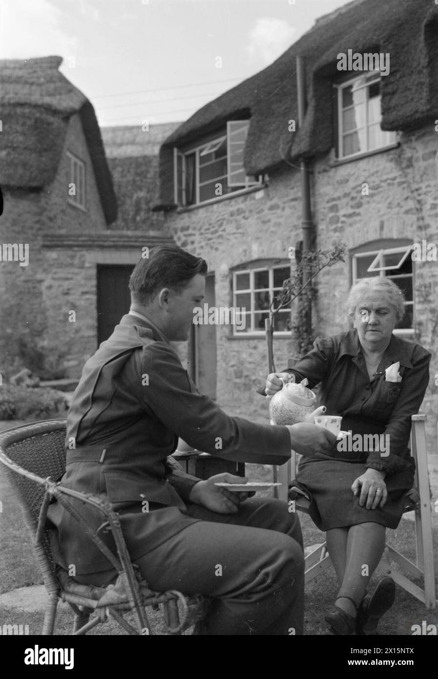 Mrs Howarth serves tea to Sergeant Harold D. Kregar in her garden at ...