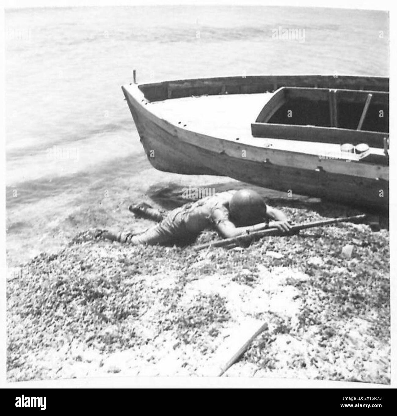 TUNIS ( VARIOUS) - The end of a fruitless attempt at escaping from our forces. An Italian soldier lies dead beside the boat which he hoped to use The vigilance of the Allied Air Forces was too much for these amateur sailors British Army Stock Photo