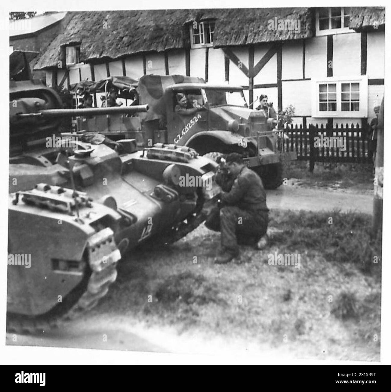 BUMPER EXERCISE - Ancient and Modern. Modern war machines outside an Elizabethan Cottage British Army Stock Photo