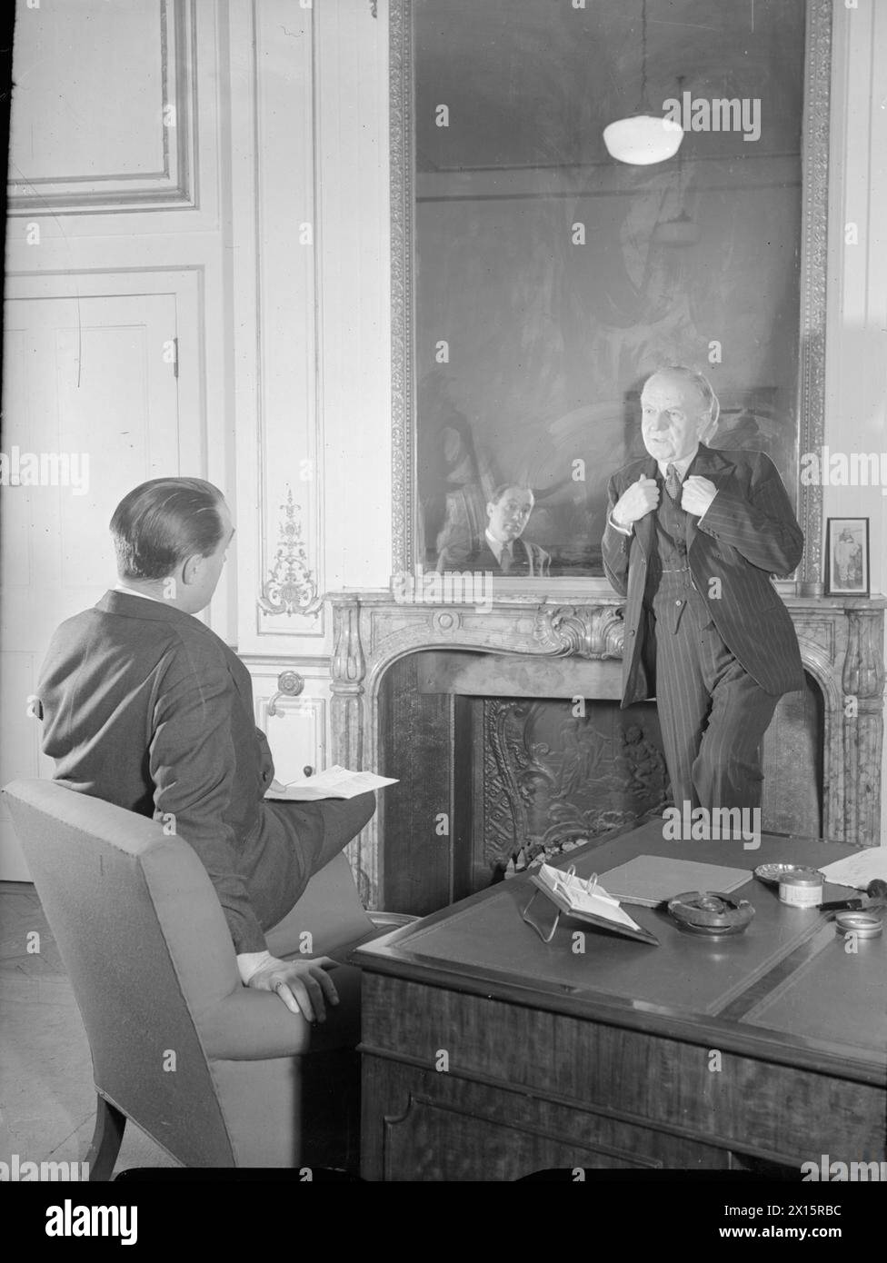 Lord Woolton, Minister for Reconstruction, is interviewed by Howard Marshall in London in 1944 about plans for reintegrating military forces into civilian life after the war. Stock Photo