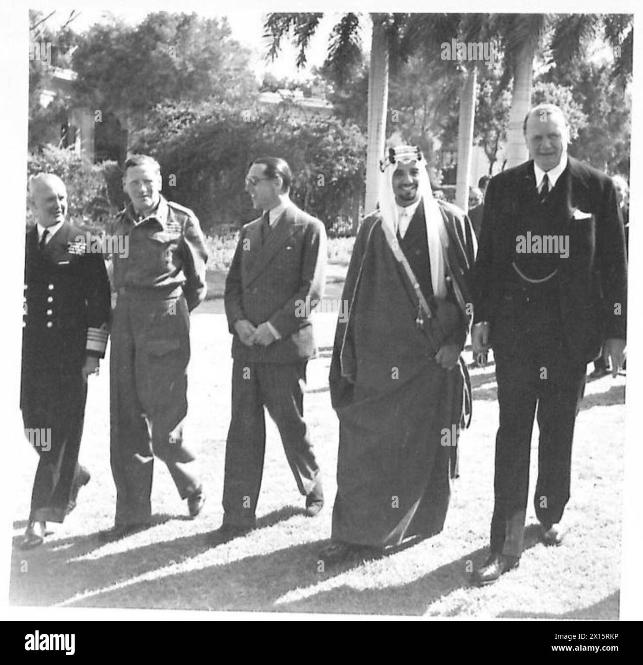 HRH EL EMIR MANSUR IBN SAUD AT THE BRITISH EMBASSY IN CAIRO - Strolling in the Embassy grounds are, left to right:-Admiral Sir Andrew Cunningham, General Sir Claude Auchinleck, Sir Walter Monckton, HRH the Emir Mansur Ibn 'Abd al-'Aziz Bin Saud, Sir Miles Lampson Stock Photo