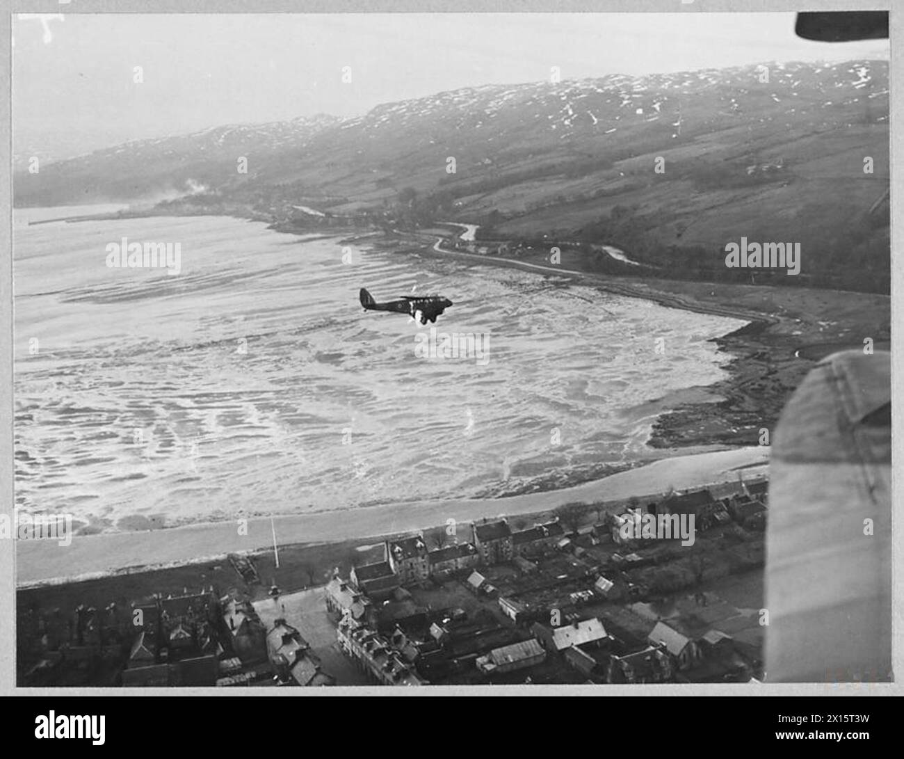 R.A.F. TRANSPORT COMMAND 'INTERNAL' FLYING - 14710 Picture (issued 1945) shows - A Dominie upproaching Colonsay Island, on the journey to Benbecula, in the Outer Hebrides Royal Air Force Stock Photo