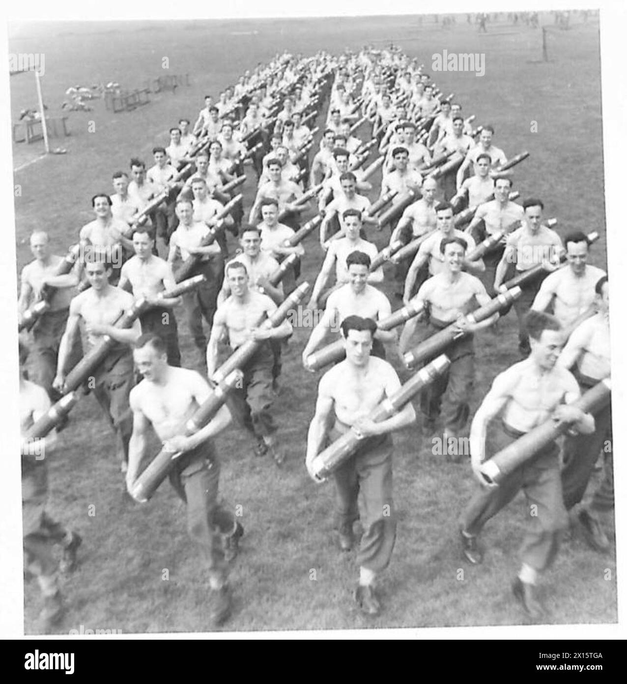 Gunners run with 49 lb dummy anti-aircraft rounds during a rehearsal ...