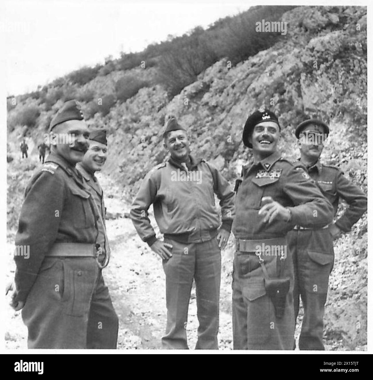 ALLIED ARMIES IN THE ITALIAN CAMPAIGN, 1943-1945 - From left to right: General Nikodem Sulik, the CO of the 5th Kresowa Division, unknown American officer, General Jacob Devers, the Deputy Supreme Allied Commander of the Mediterranean Theatre, General Władysław Anders, the CO of the 2nd Polish Corps, and Brigadier Eric Herbert Cokayne Frith, British Liaison Officer with the 2nd Polish Corps, pause for a rest when climbing to an observation post to watch a small scale exercise by Polish infantry (probably soldiers of the 6th 'Lwów' Infantry Brigade).Photograph taken during one of General Devers Stock Photo