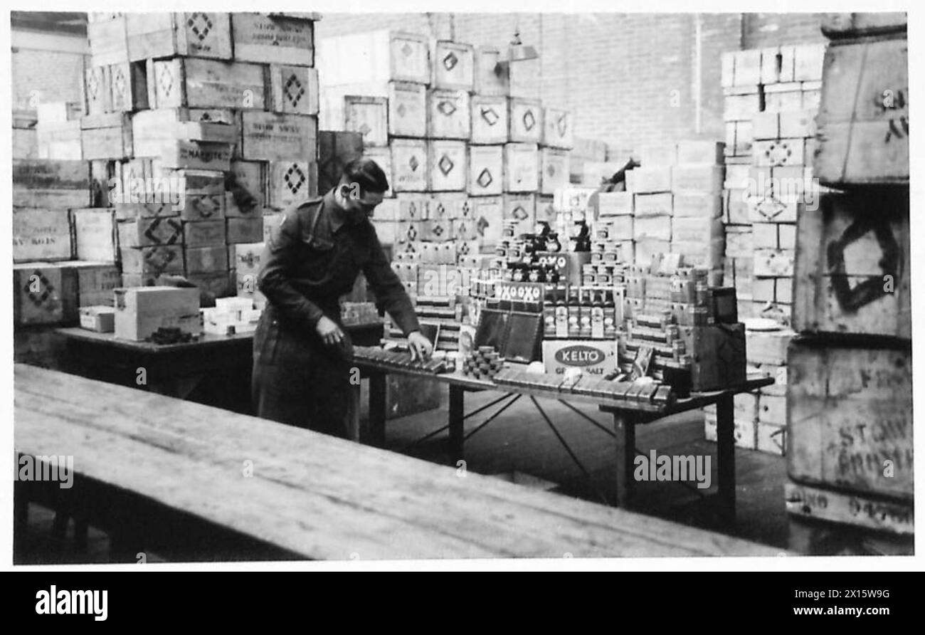 THE BLACK MARKET - L/Cpl Duffy, from Derby, takes a pride in his stall at NAAFI HQ British Army, 21st Army Group Stock Photo
