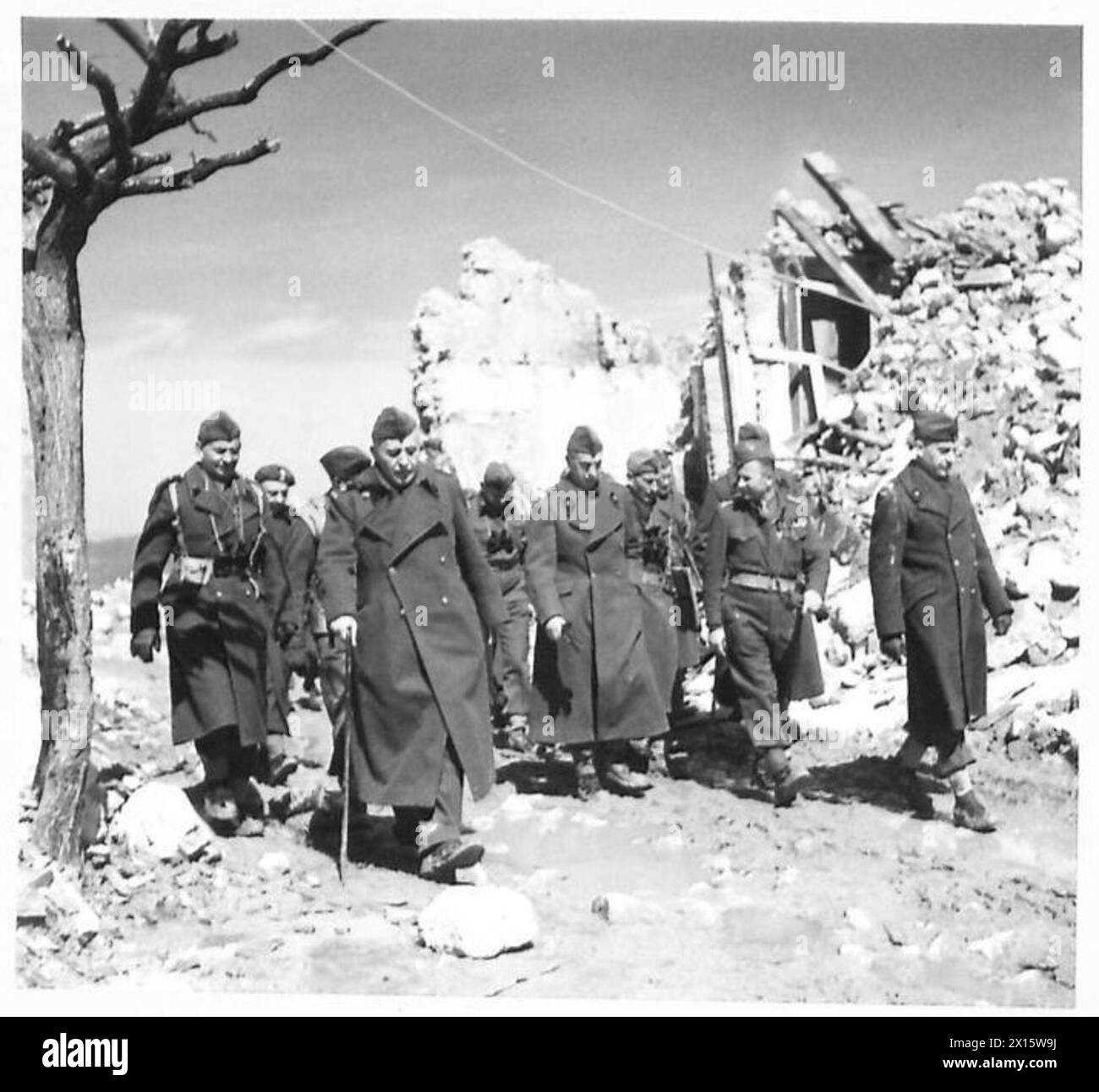 THE POLISH ARMY IN THE ITALIAN CAMPAIGN, 1943-1945 - Archbishop Józef Gawlina, the Chief Chaplain of the Polish Armed Forces, is on the left (with a walking stick). Generals Stanisław Kopański, the Chief of the Polish General Staff, and Bolesław Duch, the Commander of the Division, are both on the far right. General Kazimierz Sosnkowski, the C-in-C of the Polish Armed Forces, and his party walking through ruins of San Pietro Avellana during his visit to various units of the 3rd Carpathian Rifles Division (2nd Polish Corps), 28/29 March 1944 Polish Army, Polish Armed Forces in the West, Polish Stock Photo