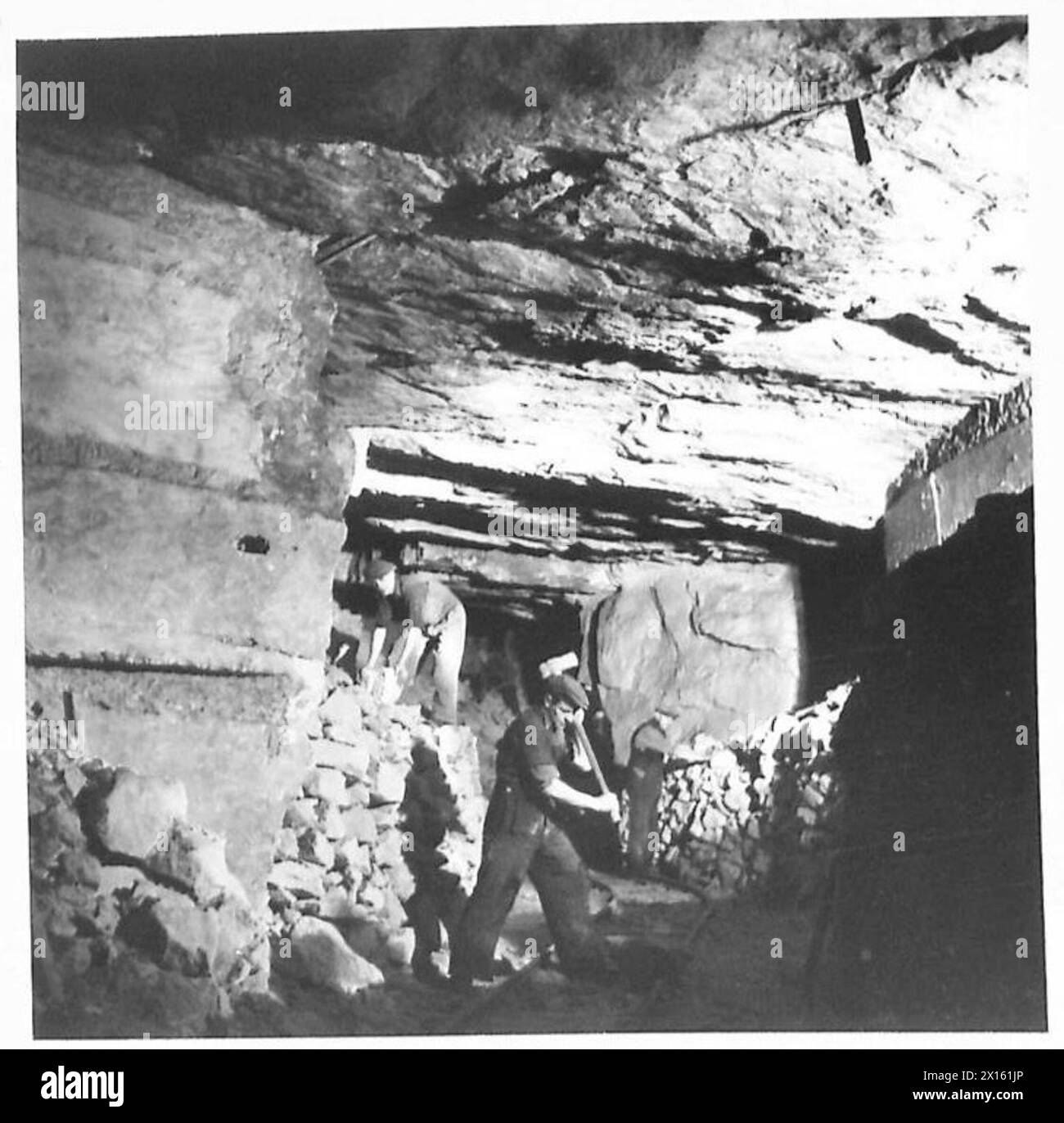 HUGE UNDERGROUND AMMUNITION DEPOT - Men at work clearing quarry debris from old workings British Army Stock Photo