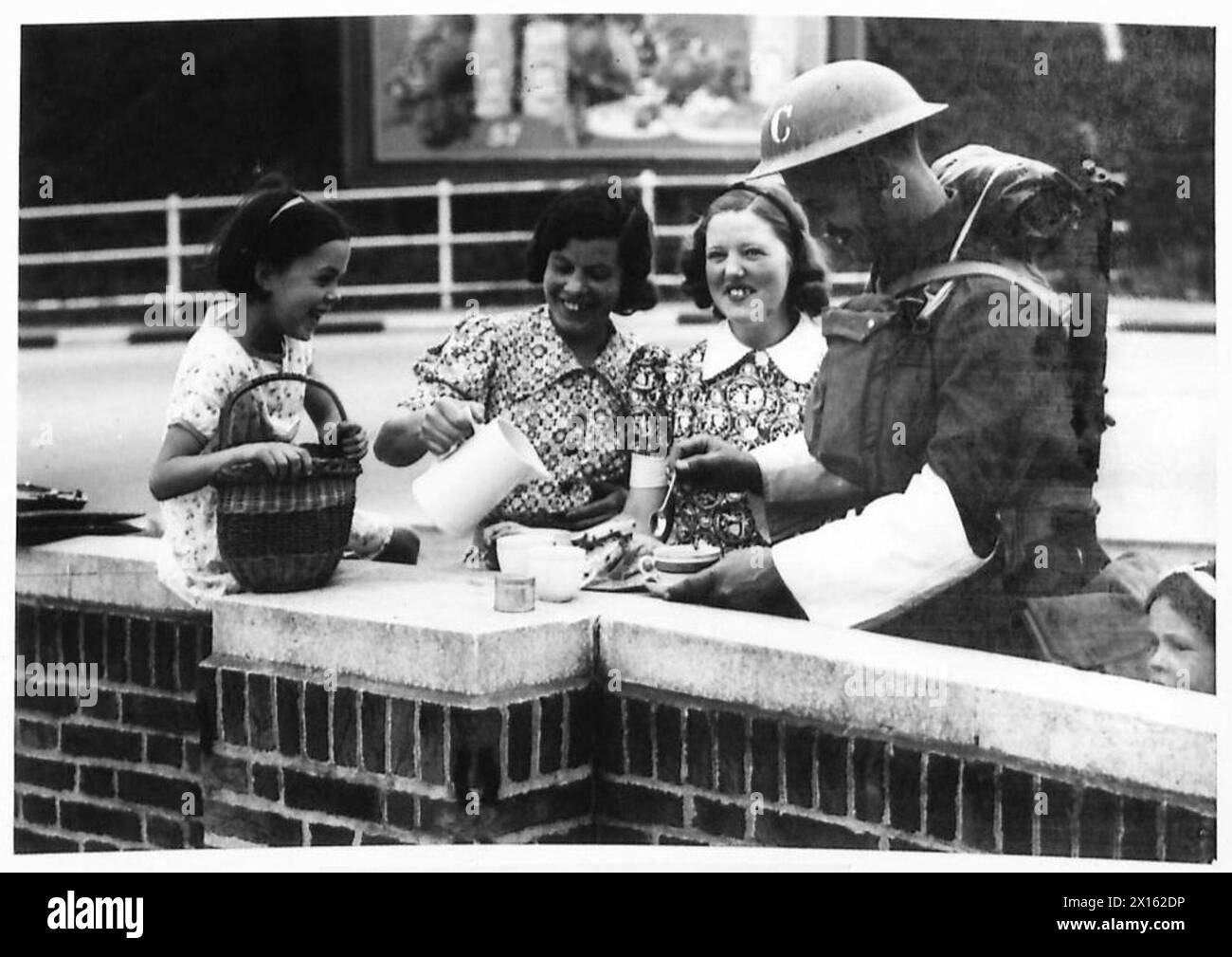 TRAFFIC CONTROL GROUP OF THE ALDERSHOT COMMAND - A welcome break. Off duty. A local resident supplying tea to the boys at rest time British Army Stock Photo