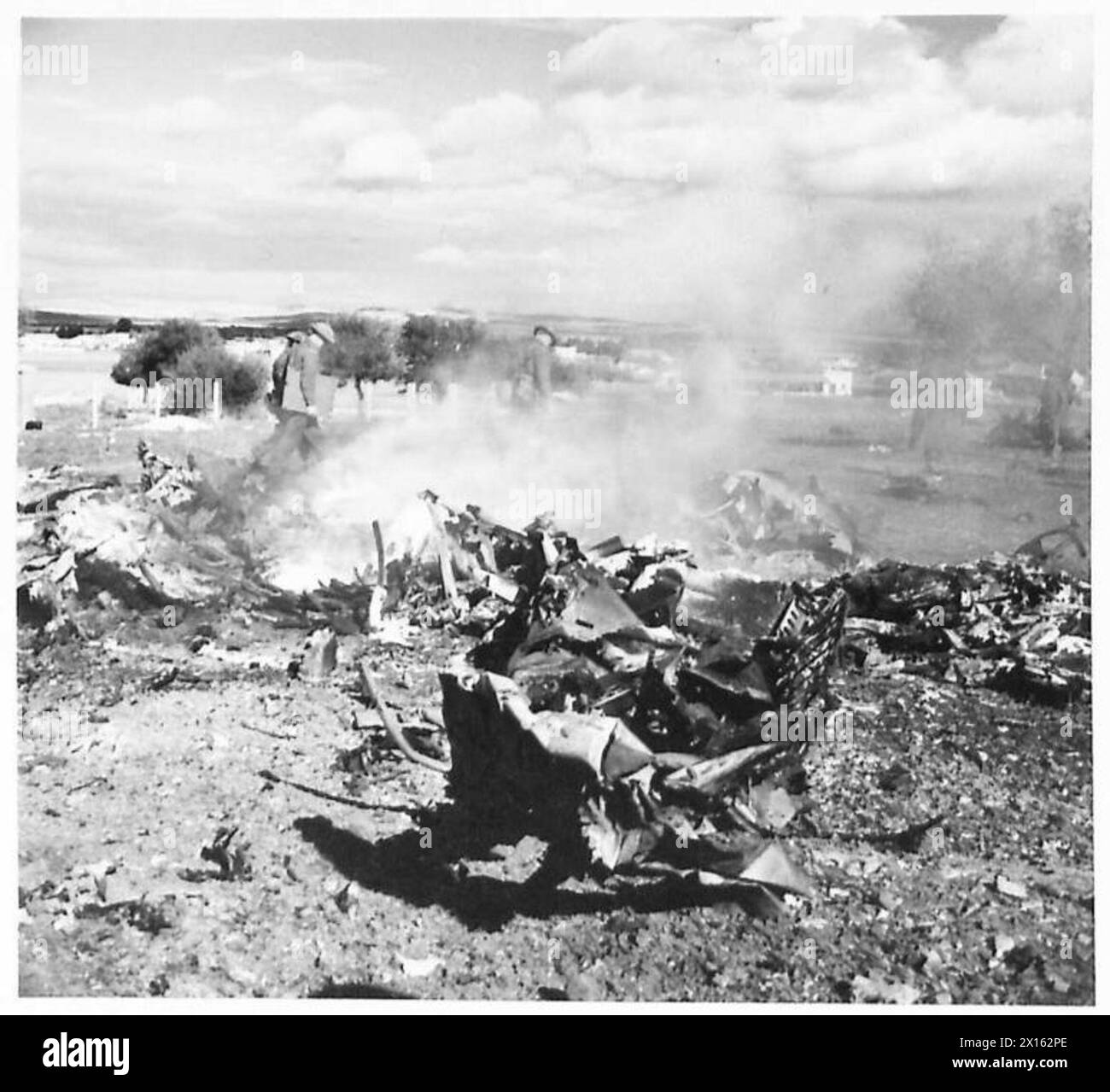 THE BRITISH ARMY IN THE TUNISIA CAMPAIGN, NOVEMBER 1942-MAY 1943 - One of the two JU 88s shot down in Bou Arada, the crew were burnt to death. The battle at Bou Arada flared up again. The Germans attacked from the "Two Tree Hill" with tanks and infantry. Troops of the British V Corps in position on the "Green Hill" (about 5000 yards away from the "Two Tree Hill") held and beat back the attack. 17 German tanks were destroyed by British 25 pounder guns. The battle continued all day with Messerschmitts and Junkers dive bombing British positions. One ME and two JU 88s were shot down. 18 January 19 Stock Photo