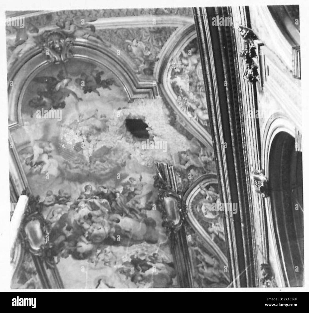 ITALY : FIFTH ARMYDAMAGED CULTURAL BUILDINGS IN NAPLES - This well-known Church was slightly damaged when a small bomb penetrated the roof, making a crater some four feet in diameter in the floor of the Church. This picture shows the point of penetration in the roof. Owing to the lapse of time no damage can be seen in the Church as repairs have already been effected British Army Stock Photo