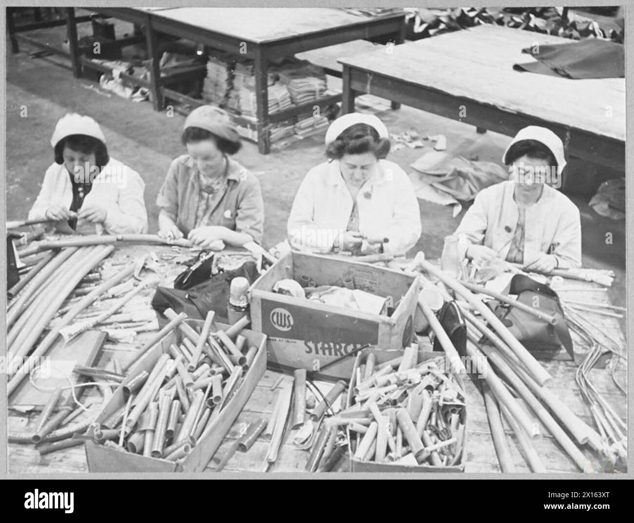 BRITAIN'S RECORD AIRCRAFT PRODUCTION ASSEMBLY OF 'WELLINGTON' BOMBERS - Women making casings for pipes and cables Royal Air Force Stock Photo