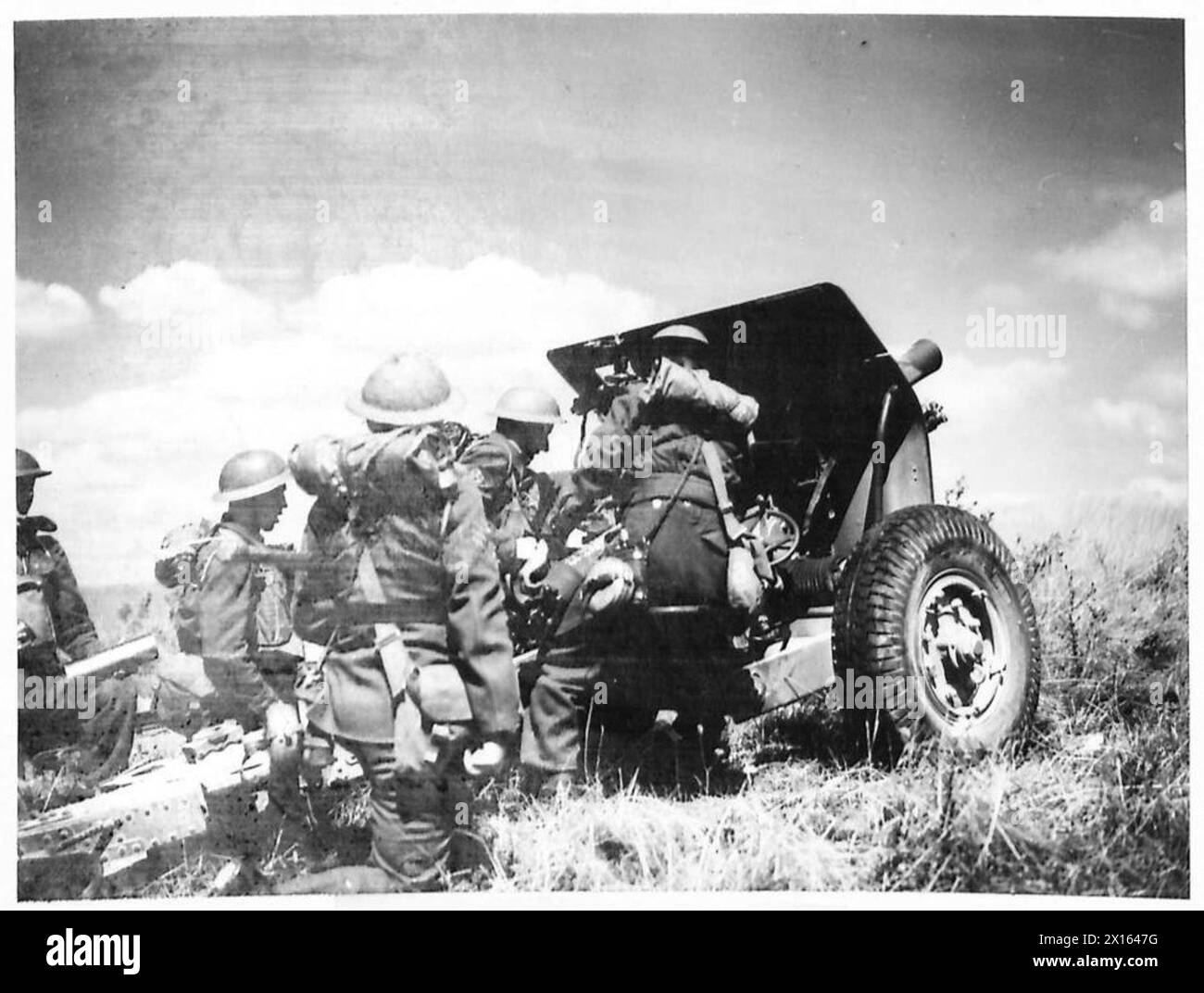 A British Army field regiment trains in gun ranging, adjusting ...