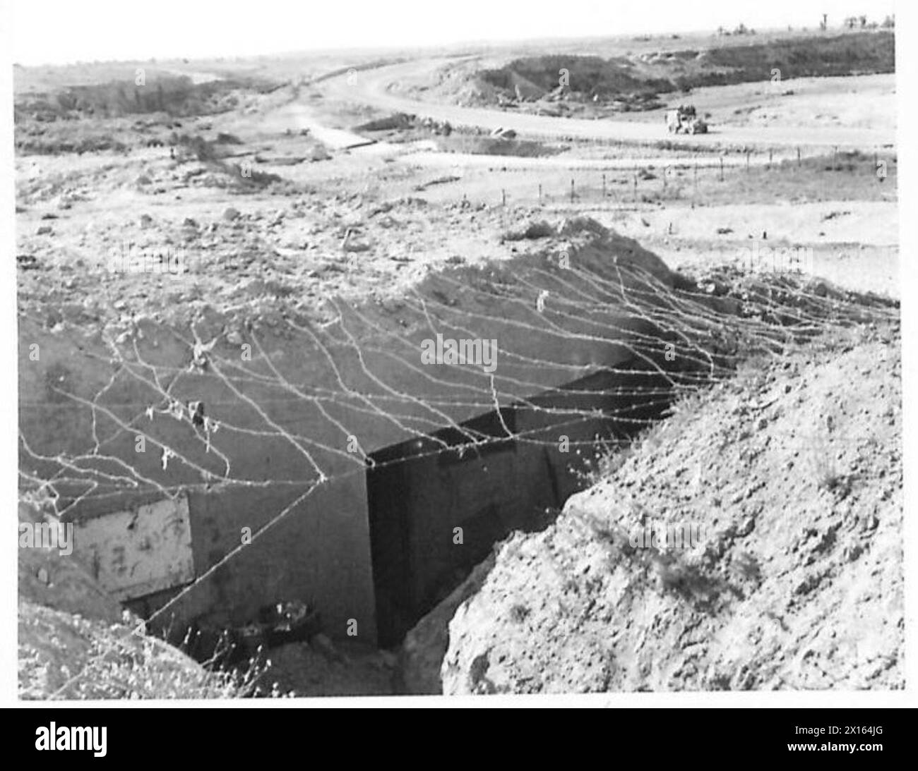 Photographs show the British Eighth Army capturing a section of the Mareth Line, with the enemy having abandoned the position overnight. Stock Photo
