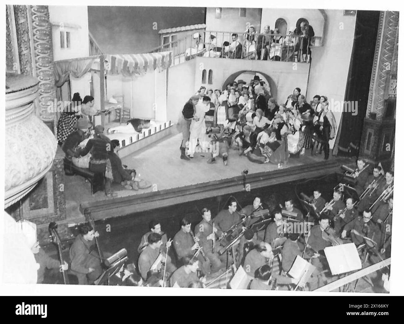 THE ARMY PRODUCES AN OPERA - The final act of 'I Pagliacci' produced in the Western Command by the Army. They have also formed a symphony orchestra, part of which is seen playing in the foreground The scenery was done by a corporal in the Pioneer Corps Corporal Ernest Stern, who is famous for his designs for Max Reinhardt and Erik Charell British Army Stock Photo