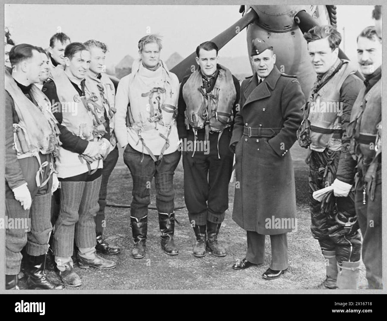 BRITAIN'S ACE FIGHTER PILOT TAKES OVER COMMANDOF A CRACK FIGHTER STATION - 8103 Group Captain A.G. Malan talking to some of the fighter pilots before they took off on a daylight sweep, on the first day of his command Royal Air Force Stock Photo