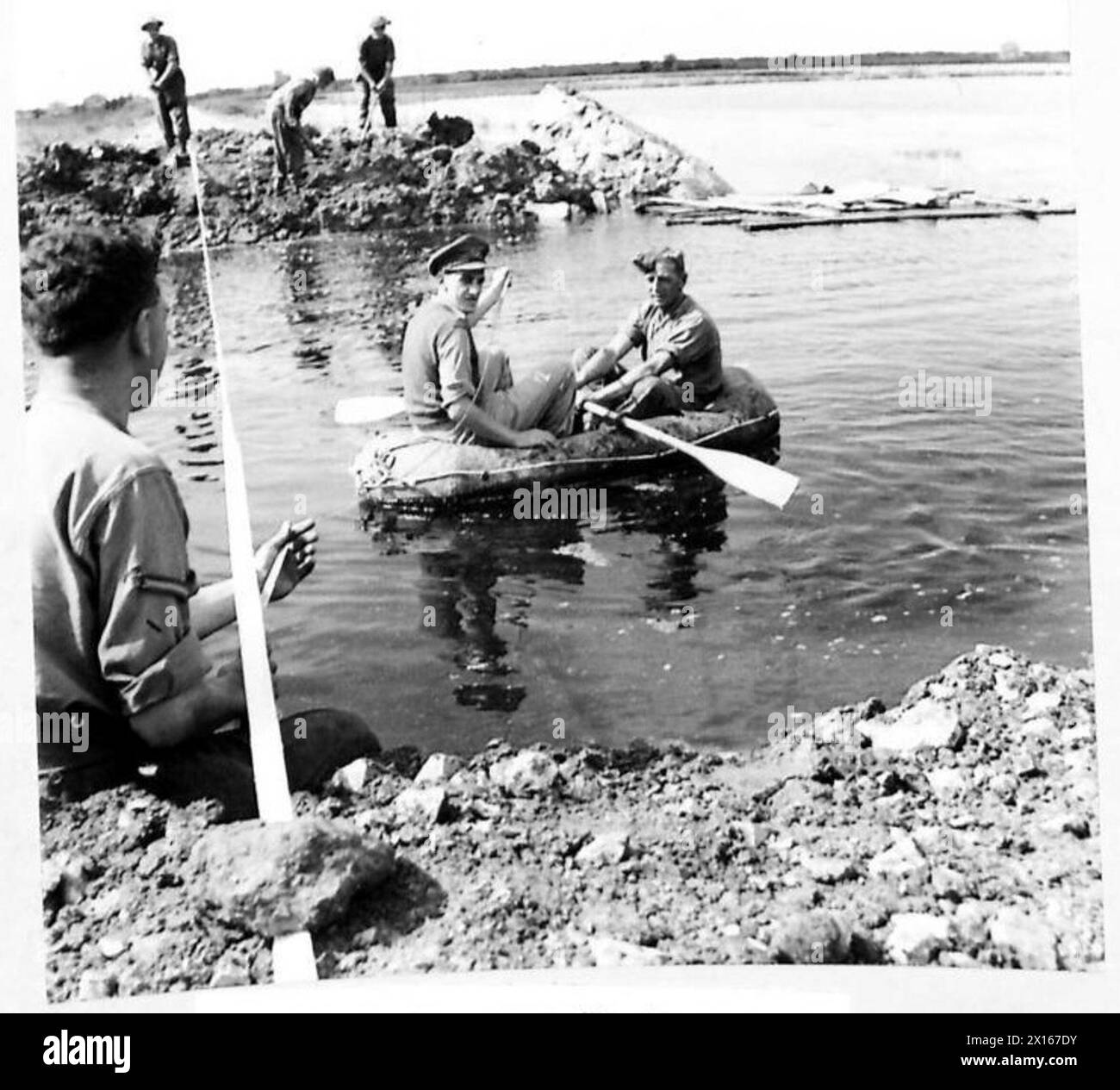 An officer of the Royal Engineers conducts a reconnaissance by boat to ...