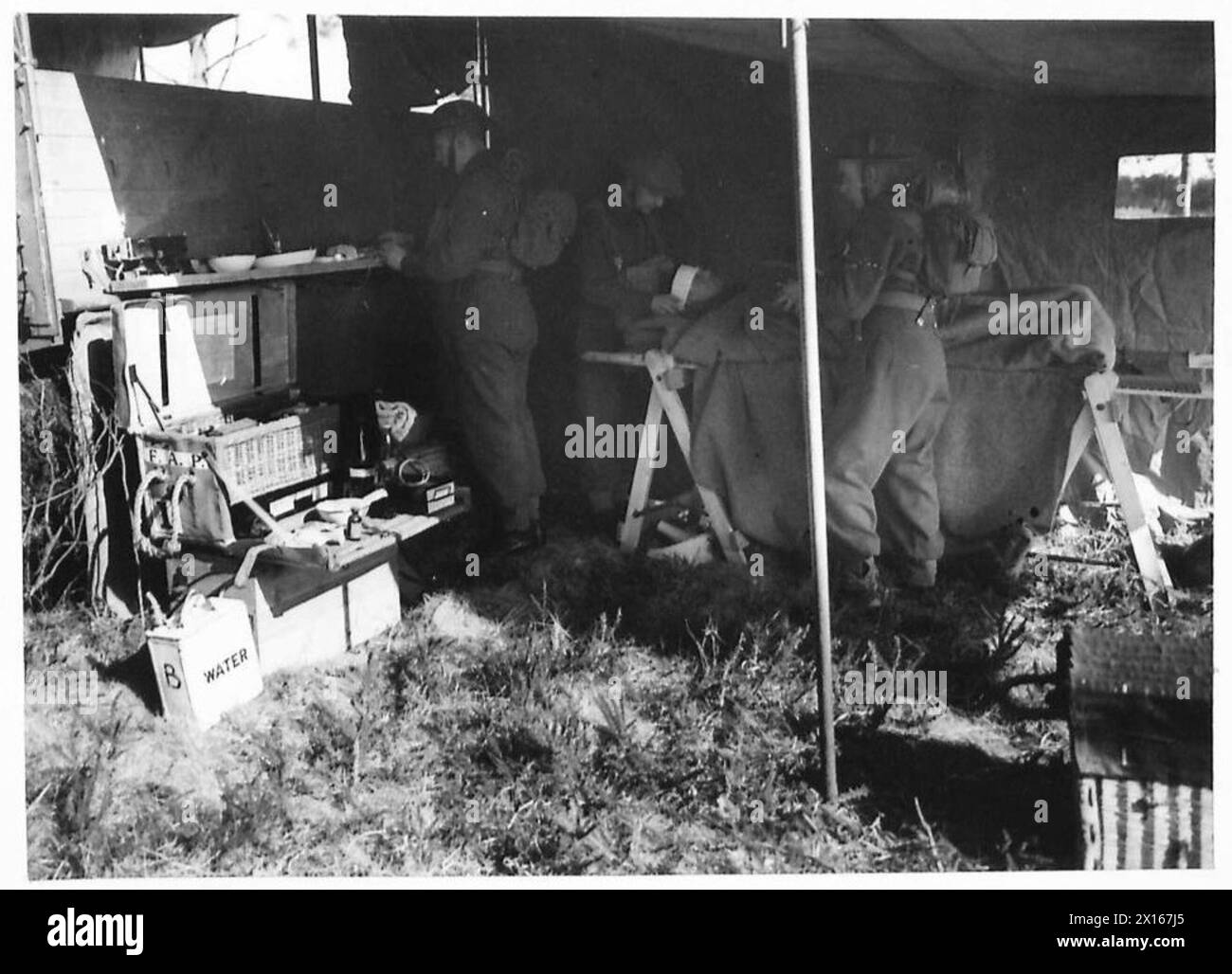 R.A.M.C. LIGHT AMBULANCE UNIT - View of inside of light section showing medical officer and two N.Os working on a casualty British Army Stock Photo