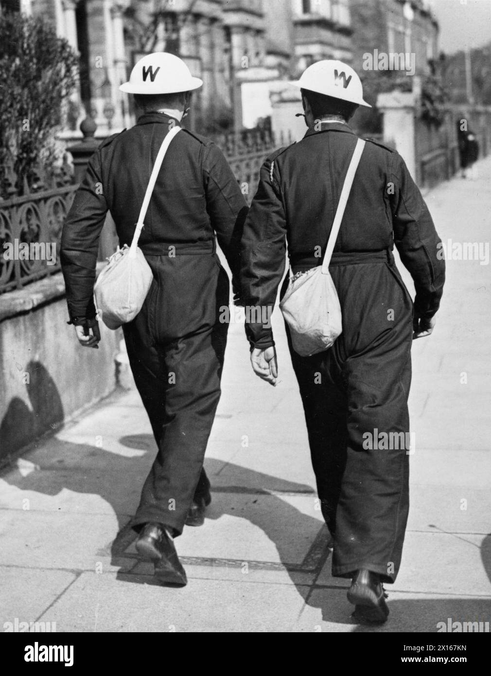 THE HOME FRONT IN BRITAIN DURING THE SECOND WORLD WAR - Two Lambeth ARP Wardens who have had their tin hats painted white to enable them to be seen during black-out hours in the event of any emergency Stock Photo