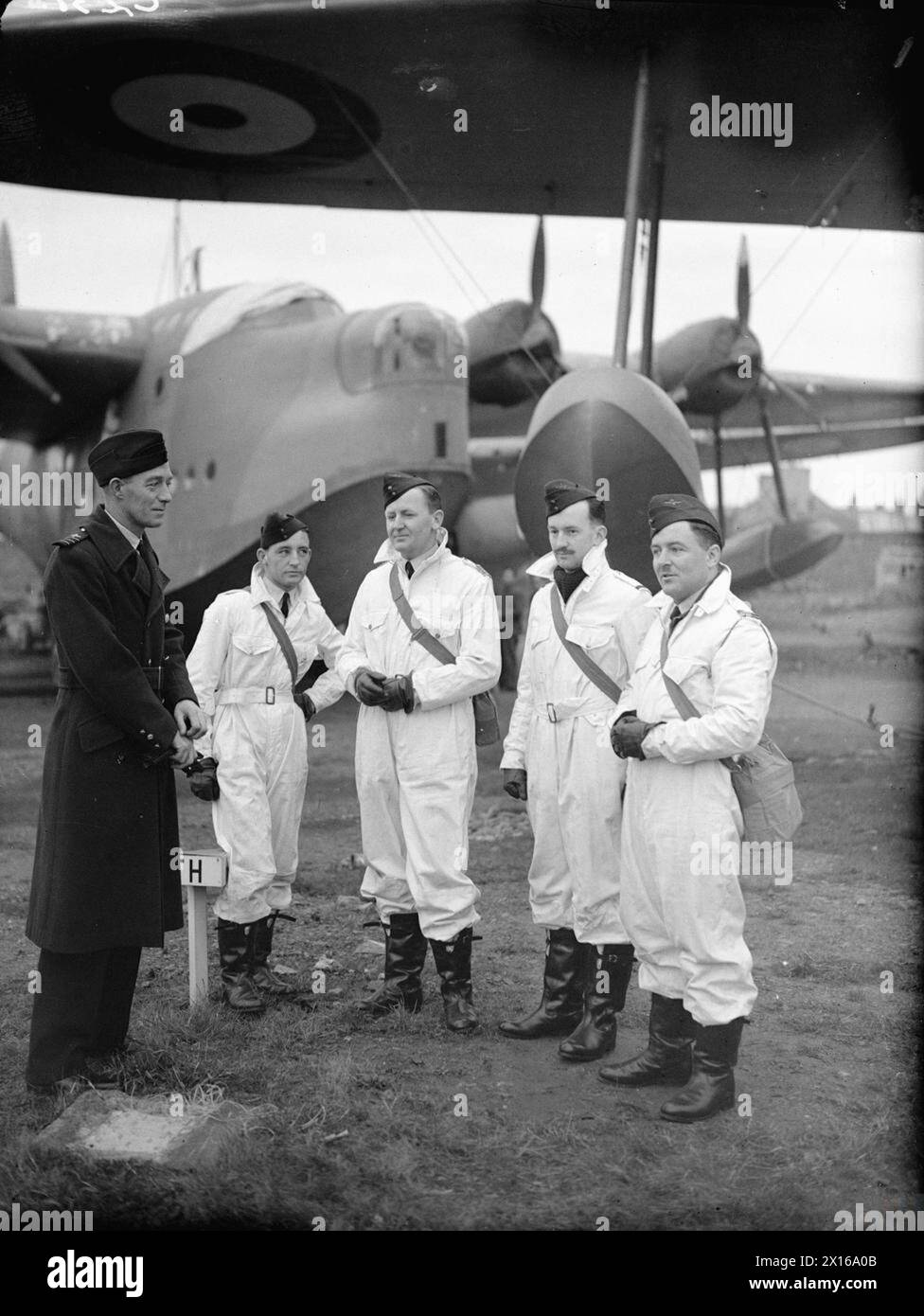 Wing Commander L.V. Lachal of No. 10 Squadron RAAF speaks with four ...