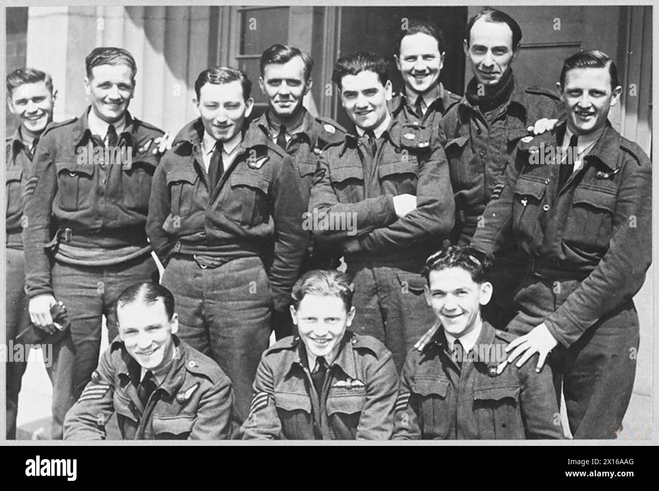 MEN BEHIND BRITAIN'S BOMBING OFFENSIVE : SERGEANT PILOTS AND CREWS [Picture issued 1942] - Sergeant pilots and crews enjoying the sun while off duty at an R.A.F. bomber Station in the U.K. 1. Sergeant W.G. Foster 2. Sergeant J.R. Brook, 3. Sergeant J. Carter 4. Sergeant G.P. Lemoine, 5. Sergeant J. Fisher 6. Sergeant K. Richards 7. Sergeant R.W. Pratt, 8. Sergeant C.F. Norman 9. Sergeant G. Ellis 10. Sergeant R.V. Morrison 11. Sergeant H.E. Allen , Royal Air Force Stock Photo