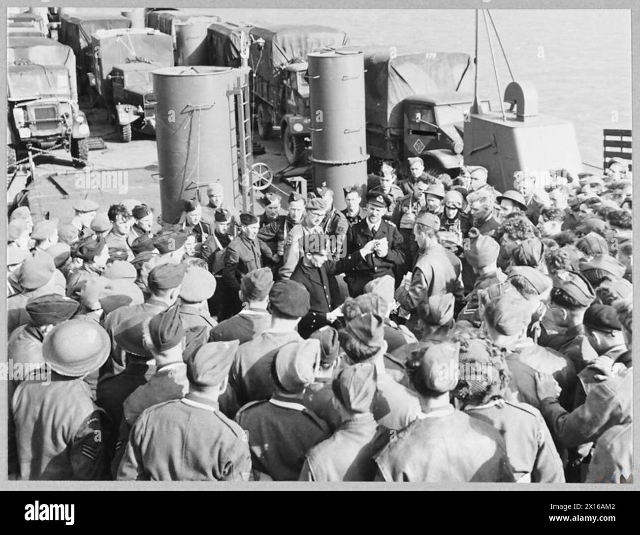 R.A.F. AND NAVY COMBINED OPERATION - 12907 Picture (issued 1944) shows - Petty Officer H. Forrest of Bournemouth, explaining emergency action stations for rafts during the exercise. Behind him are Major G. Meiklejohn and Lieutenant K.M. Dallac Royal Air Force Stock Photo