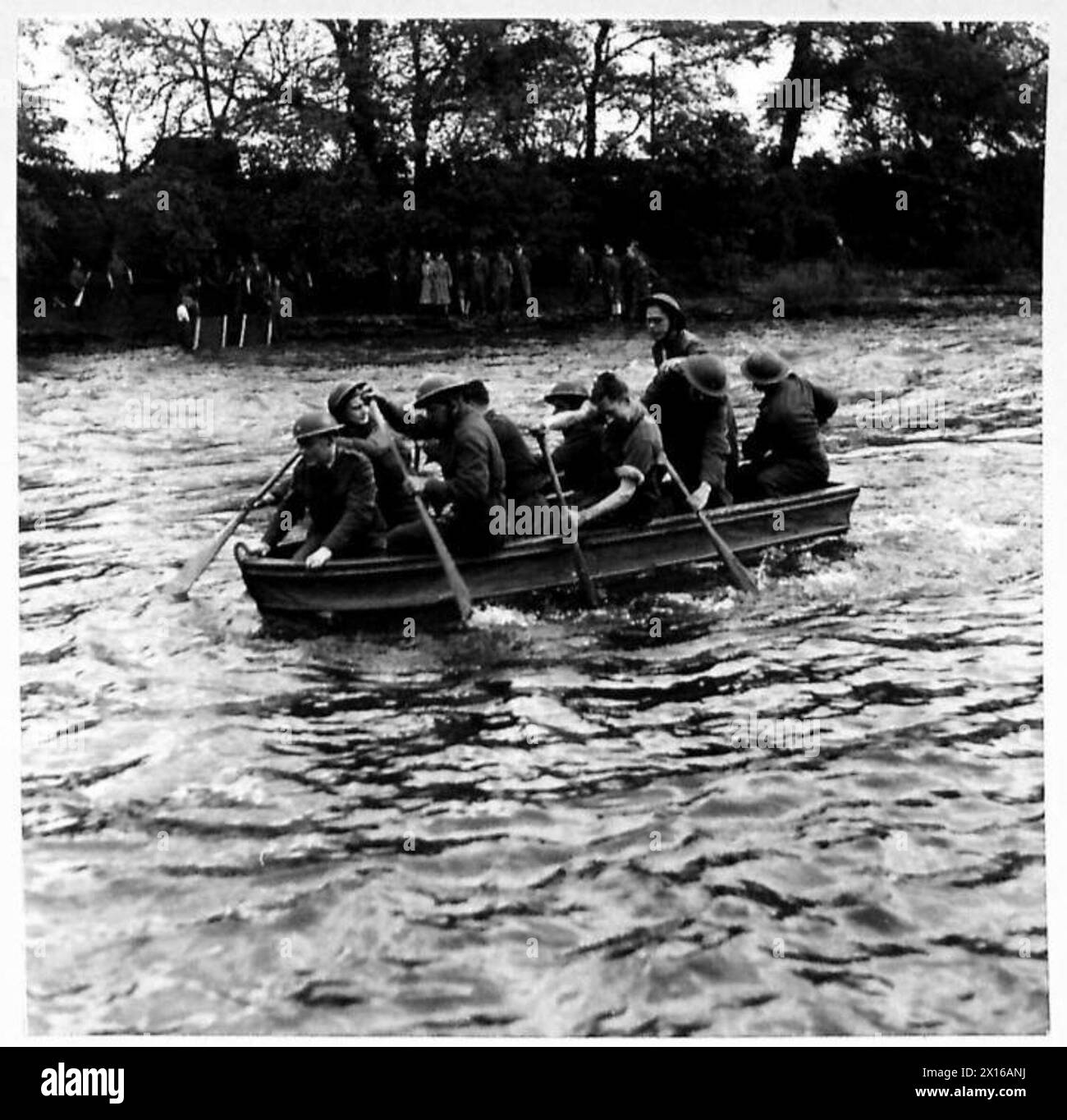A group of British Army men crosses a river during a demonstration of ...