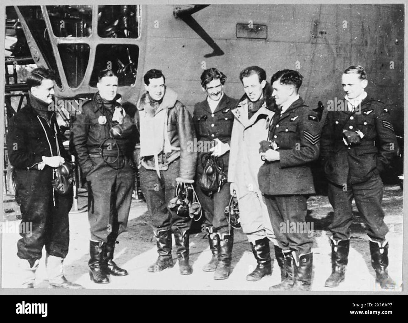 LIBERATOR AIRCRAFT IN ACTION - 4017 Seven of the crew standing deside the aircraft - Left to right - P/O Dear; P/O Neville; F/Lt.Bulloch; Sergeant McColl; Sergeant Hollies; Sergeant Turner; andSergeant Millar. Royal Air Force Stock Photo