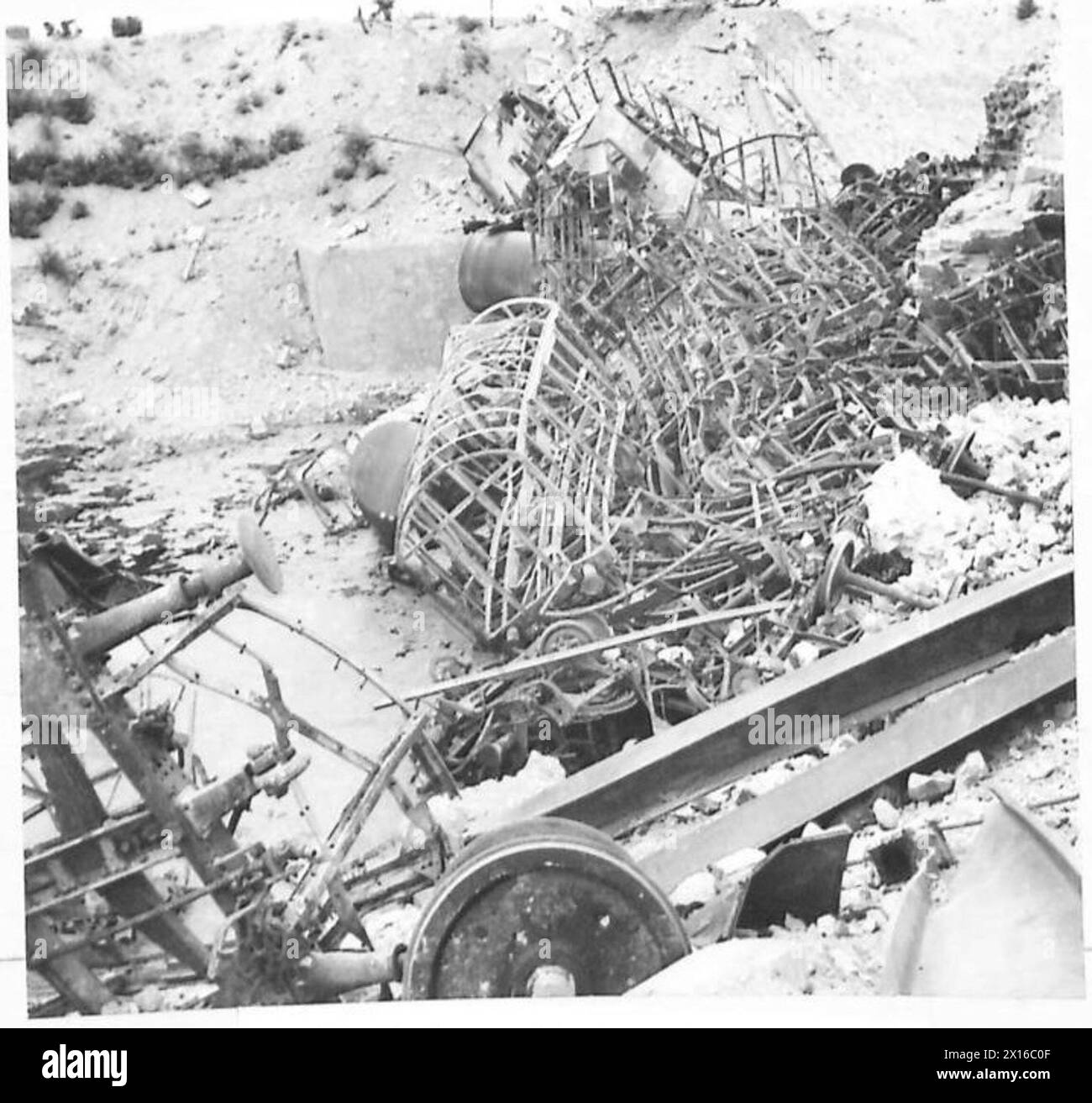 About three miles north of Arezzo, an enemy train carrying petrol, oil, troops, and war supplies was crossing a bridge over a river when Allied bombers attacked, causing damage to the railway, British Army. Stock Photo