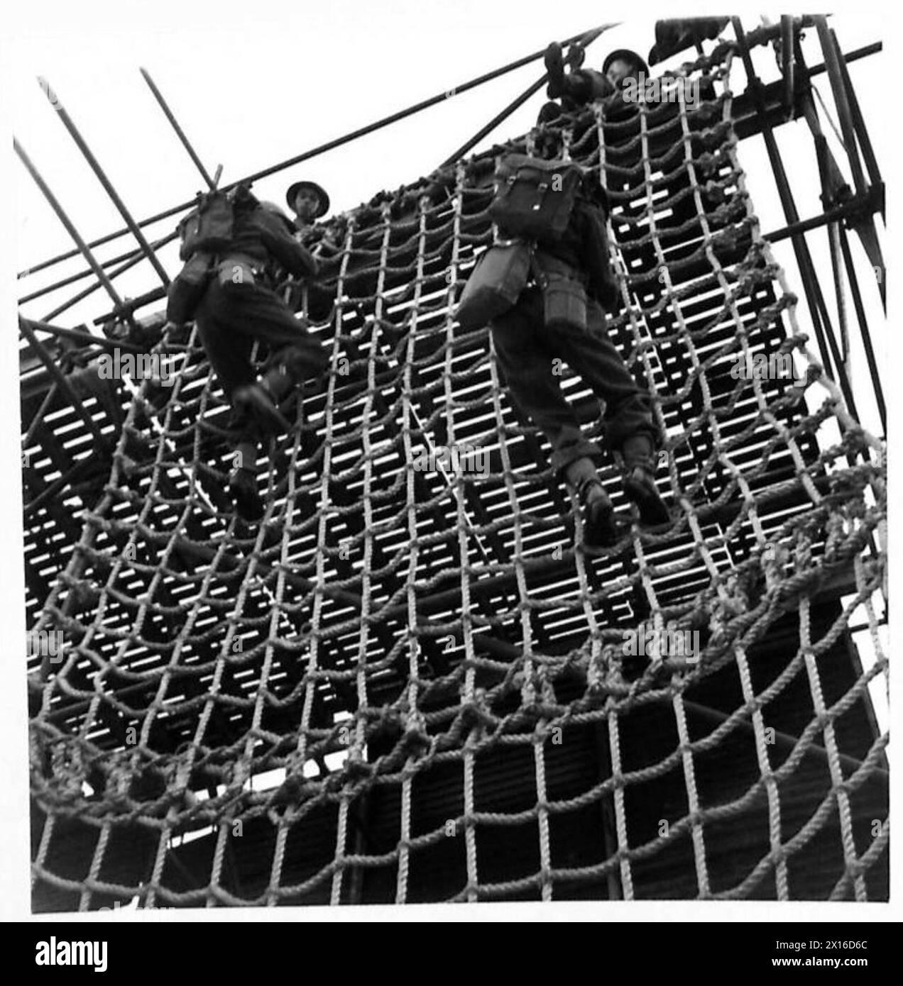 Troops at the Combined Operations School practice scaling rope ladders ...