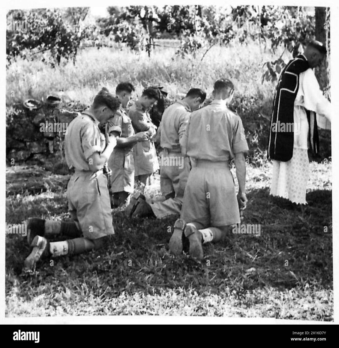 EIGHTH ARMY : VARIOUS - Rev. B.J. Costello, South African Catholic chaplain, giving a Requiem Mass for officers and men of the South African Division killed during Cassino. The small congregation is the Roman Catholic personnel of a Bde. H.Q British Army Stock Photo