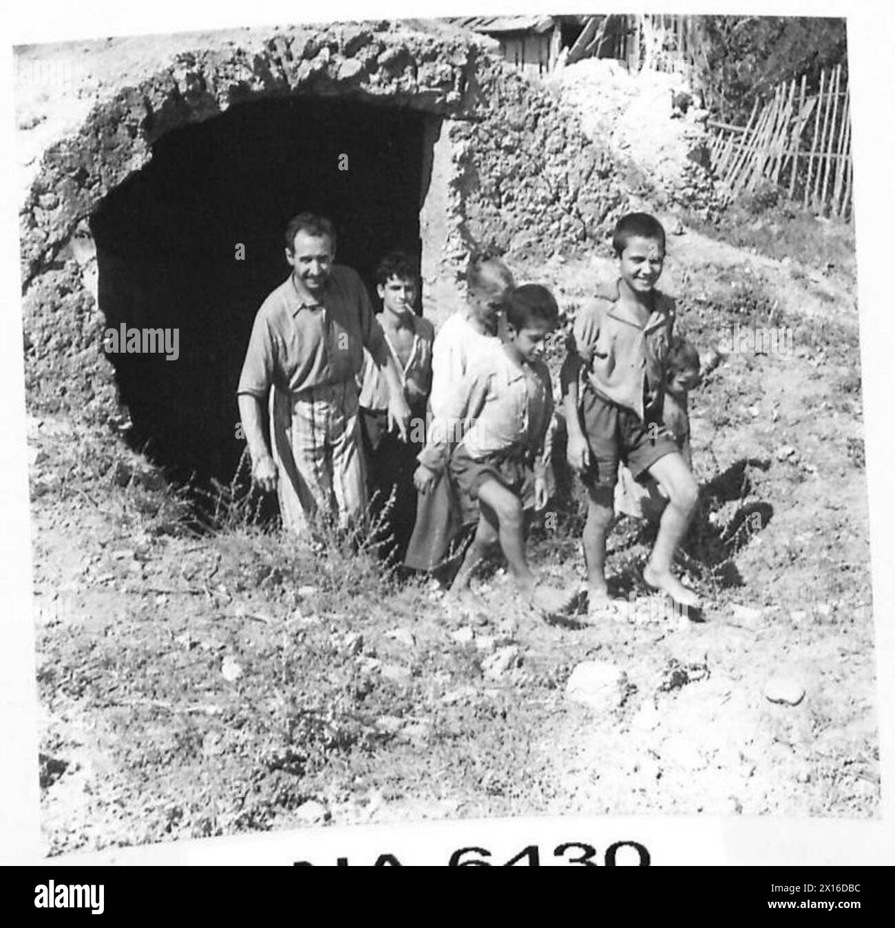 INVASION OF ITALY - An Italian family leaves a cellar in Catona where they had been sheltering from the Allied 'Blitz'. These are some of the people to whom Mr. Churchill addressed his warning that Italy would be blackened from end to end unless they accepted our terms of unconditional surrender British Army Stock Photo